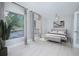 Second bedroom with hardwood floors, large windows and a comfortable bed at 620 Cranes Way # 207, Altamonte Springs, FL 32701