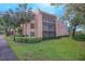 Two-story condo building with lush landscaping and screened balconies at 620 Cranes Way # 207, Altamonte Springs, FL 32701