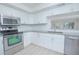 Modern kitchen featuring granite countertops and stainless steel appliances at 620 Cranes Way # 207, Altamonte Springs, FL 32701