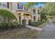 Townhome with a brick walkway and lush greenery at 11838 Deer Path Way, Orlando, FL 32832