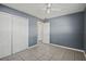 Bedroom with gray walls, tile floors, double closet and bathroom access at 1345 Nolton Way, Orlando, FL 32822