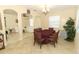 Dining room with a dark-wood table and chairs, adjacent to living room at 15121 Evergreen Oak Loop, Winter Garden, FL 34787