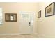 Bright entryway with a white door, mirror, and framed art at 15121 Evergreen Oak Loop, Winter Garden, FL 34787