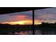 Stunning sunset view from screened porch overlooking lake at 15121 Evergreen Oak Loop, Winter Garden, FL 34787