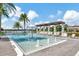 Community pool with a water feature and pergola at 15636 Shorebird Ln, Winter Garden, FL 34787