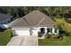 One-story house with a two-car garage, and neatly landscaped lawn at 1668 Marsh Pointe Dr, Clermont, FL 34711