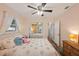 Spacious bedroom with ceiling fan and sliding barn door at 2455 Waycross Ave, Eustis, FL 32726