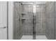 Modern shower with gray tile and glass enclosure at 26261 Feathergrass Cir, Leesburg, FL 34748