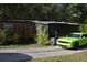 Mobile home with carport and green car parked in driveway at 4750 N Ronald Reagan Blvd, Sanford, FL 32771