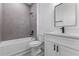 Modern bathroom with gray tile and white vanity at 6770 Sw 149Th Lane Rd, Ocala, FL 34473