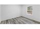 Simple bedroom with wood-look floors and a window at 6770 Sw 149Th Lane Rd, Ocala, FL 34473