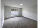 Well-lit bedroom with gray carpeting and a window at 7 Bolton Ct, Kissimmee, FL 34758