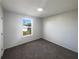 Bright bedroom with carpeted floor and a window offering natural light at 7 Bolton Ct, Kissimmee, FL 34758