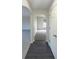 View down hallway showcasing an archway and carpeted floor at 7 Bolton Ct, Kissimmee, FL 34758