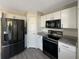 Modern kitchen with black appliances and granite countertops at 7 Bolton Ct, Kissimmee, FL 34758