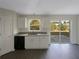 Kitchen with granite countertops, stainless steel dishwasher, and sliding door to backyard at 7 Bolton Ct, Kissimmee, FL 34758