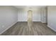 Open living area with wood-look floors and arched hallway at 7 Bolton Ct, Kissimmee, FL 34758