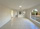 Bright and airy living room with tile floors and access to the kitchen at 7 Bolton Ct, Kissimmee, FL 34758
