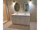 Bathroom with double vanity, large mirrors, and tile floors at 7001 Hershey Way, Orlando, FL 32822