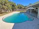 Inviting kidney-shaped pool with covered patio at 7001 Hershey Way, Orlando, FL 32822