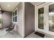 Welcoming front porch with seating, glass front door and hanging plant at 710 Prince Edward Ave, Clermont, FL 34711