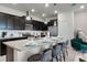 Modern kitchen with dark cabinetry, granite countertops and breakfast bar at 7420 Oakmoss Loop, Davenport, FL 33837