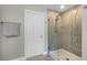 Bathroom with glass shower, tile surround and walk-in closet at 7670 Modica St, Clermont, FL 34714