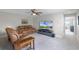 Relaxing loft area with comfortable seating and large TV at 7670 Modica St, Clermont, FL 34714