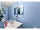 Small bathroom with light blue walls and vanity at 800 Daybreak Dr, Fruitland Park, FL 34731