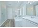 Elegant bathroom with white vanity, soaking tub, glass shower, and dual sinks at 840 Livestock Loop, St Cloud, FL 34771