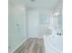 Bright, modern bathroom with a walk-in shower, soaking tub, and white vanity at 840 Livestock Loop, St Cloud, FL 34771