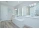 Modern Primary bathroom with double vanities, a soaking tub, and a walk-in shower at 840 Livestock Loop, St Cloud, FL 34771