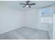 Bright bedroom with gray carpeting, ceiling fan, and window with white curtains at 840 Livestock Loop, St Cloud, FL 34771