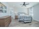 Cozy bedroom with wooden furniture, plaid bedding, and ceiling fan at 840 Livestock Loop, St Cloud, FL 34771
