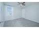 Empty bedroom with gray carpet, ceiling fan, and a closed door at 840 Livestock Loop, Saint Cloud, FL 34771