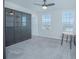 Bonus room or office with gray carpet, built-in dark wood cabinets, and small round table at 840 Livestock Loop, St Cloud, FL 34771