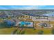 Community pool with a separate shallow end for children, nearby playground, and several homes at 840 Livestock Loop, St Cloud, FL 34771