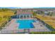 Aerial view of a community pool with lounge chairs, umbrellas, and a pool house at 840 Livestock Loop, St Cloud, FL 34771