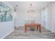 Charming dining area with a wood table, chandelier, and large window at 840 Livestock Loop, St Cloud, FL 34771