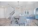 Elegant dining room with a stylish chandelier, a round table, and large windows overlooking the water at 840 Livestock Loop, St Cloud, FL 34771