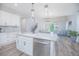 Modern kitchen with white shaker cabinets, a large island, stainless steel appliances, and an open floor plan at 840 Livestock Loop, St Cloud, FL 34771