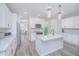 Bright, spacious kitchen featuring white cabinets, stainless steel appliances, and an island with seating at 840 Livestock Loop, St Cloud, FL 34771