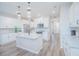 Modern kitchen with white shaker cabinets, granite countertops, stainless steel appliances, and an island at 840 Livestock Loop, St Cloud, FL 34771