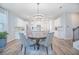 Open kitchen and dining area with white cabinets, stainless steel appliances, and a central island at 840 Livestock Loop, St Cloud, FL 34771