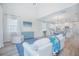 Bright living room with a comfortable white sofa, a blue rug, and an adjacent dining area and kitchen at 840 Livestock Loop, St Cloud, FL 34771