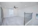 Spacious carpeted loft with built-in shelves and elegant metal railing at 840 Livestock Loop, St Cloud, FL 34771