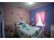 Charming bedroom with Stitch bedding and pastel decor at 881 Orchid Grove Blvd, Davenport, FL 33837