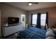 Comfortable bedroom with a king-size bed, built-in desk, and en-suite bathroom at 881 Orchid Grove Blvd, Davenport, FL 33837