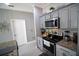 Modern kitchen with stainless steel appliances and granite countertops at 881 Orchid Grove Blvd, Davenport, FL 33837