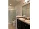 Bathroom with double vanity, shower, and grab bars at 146 Prairie Falcon Dr, Groveland, FL 34736
